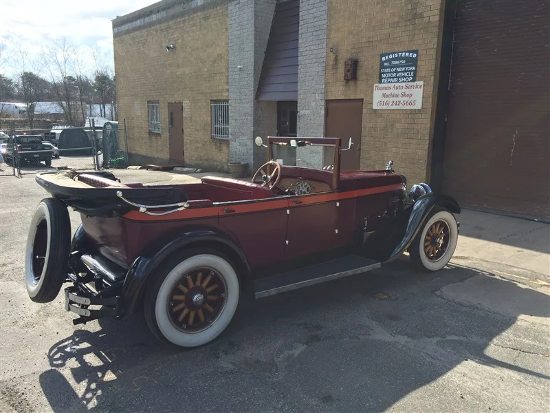 old classic car with large whitewall tires