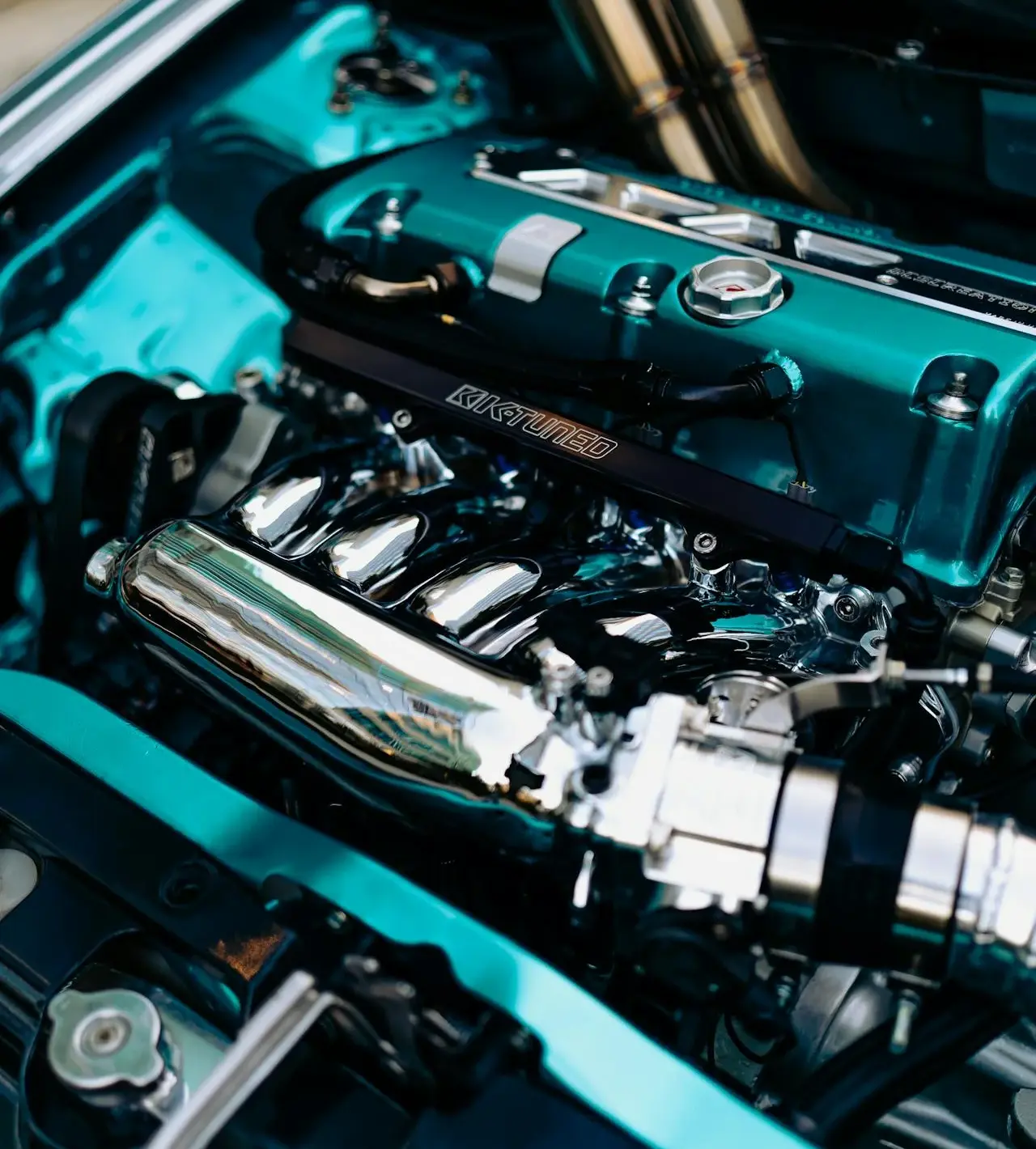 teal car open hood